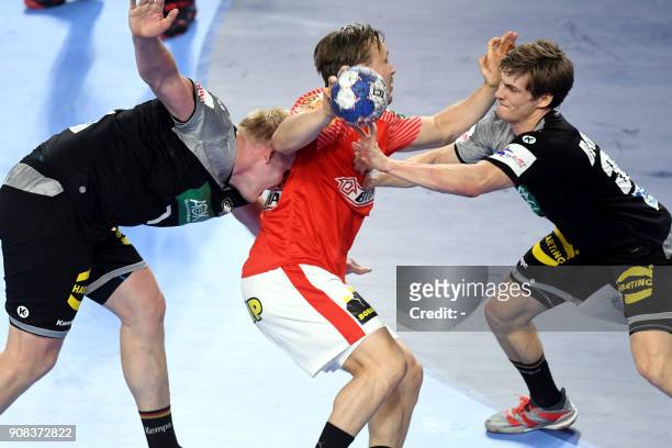 Denmark's Morten Toft Olsen vies with Germany's Patrick Wiencek and Rune Dahmke during the group II match of the Men's 2018 EHF European Handball...