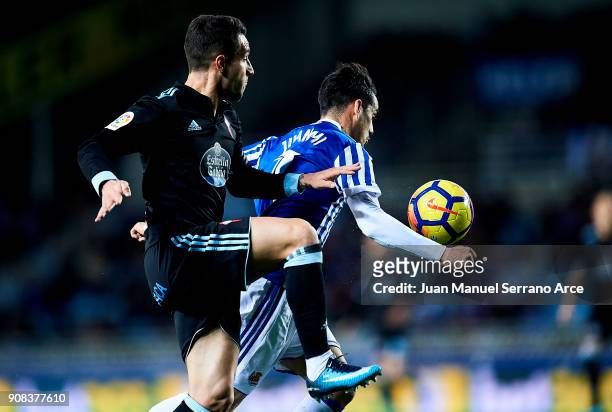 Hugo Mallo of RC Celta de Vigo duels for the ball with Juan Miguel Jimenez 'Juanmi' of Real Sociedad during the La Liga match between Real Sociedad...