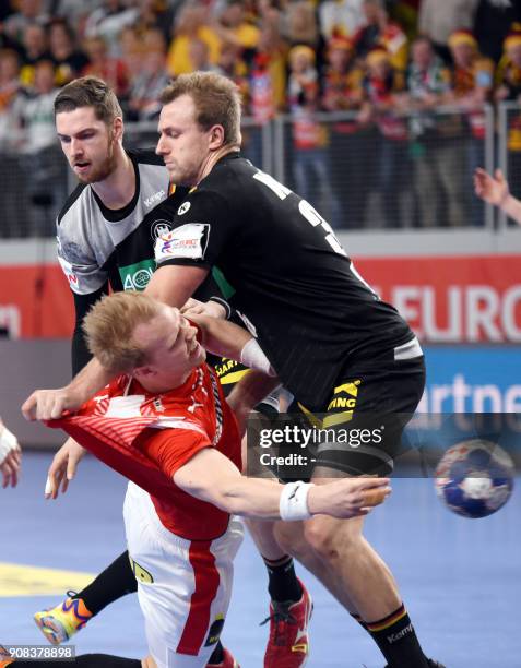 Denmark's Anders Zachariassen vies with Germany's Hendrik Pekeler and Julius Kuhn during the group II match of the Men's 2018 EHF European Handball...