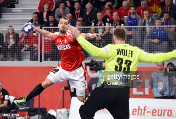 Denmark's Casper U. Mortensen shoots on goal past Germany's goalkeeper Andreas Wolf during the group II match of the Men's 2018 EHF European Handball...