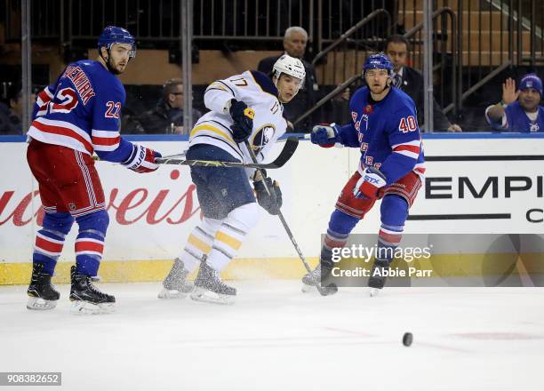 Jordan Nolan of the Buffalo Sabres, Kevin Shattenkirk and Michael Grabner of the New York Rangers watch the puck in the third period during their...