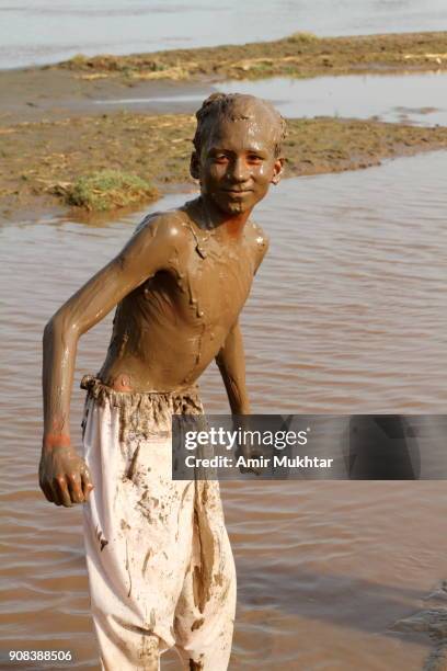 mud therapy (chocolate boy) - mud riverbed stock pictures, royalty-free photos & images