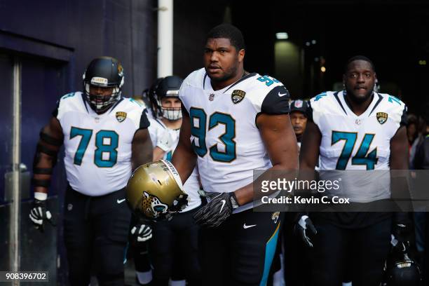 Calais Campbell of the Jacksonville Jaguars takes the field with teammates before the AFC Championship Game against the New England Patriots at...