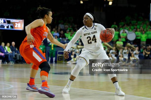 Notre Dame Fighting Irish guard Arike Ogunbowale looks to get around Clemson Tigers guard Jaia Alexander during the game between the Clemson Tigers...