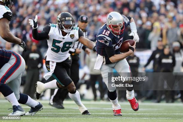 Tom Brady of the New England Patriots is pursued by Dante Fowler Jr. #56 of the Jacksonville Jaguars in the first quarter during the AFC Championship...