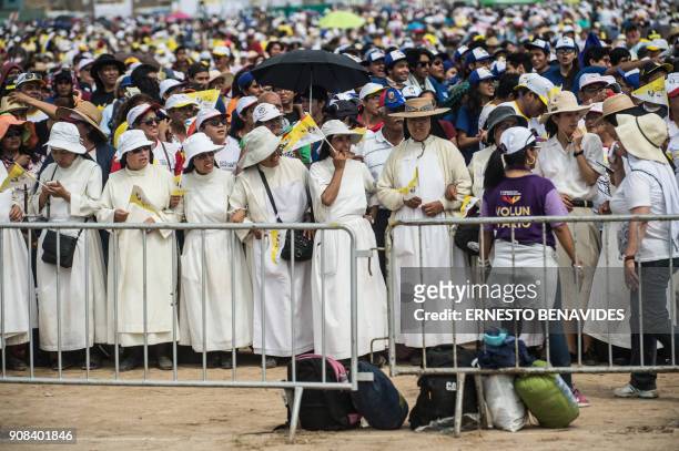 Nuns wait for the arrival of Pope Francis at the Las Palmas air base in Lima, where the pontiff will celebrate mass, on January 21, 2018. Pope...