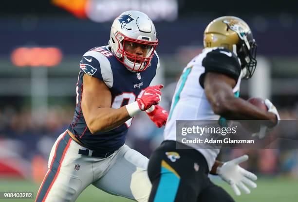 Leonard Fournette of the Jacksonville Jaguars carries the ball as he is defended by Trey Flowers of the New England Patriots in the first quarter...