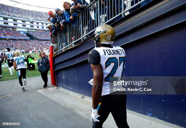 Leonard Fournette of the Jacksonville Jaguars walks onto the field before the AFC Championship Game against the New England Patriots at Gillette...