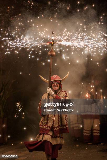 Participant of the &quot;Ball de Diables&quot;, dance of devils, runs with fireworks during the celebrations of the &quot;Nit del Foc&quot;, night of...
