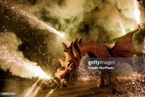 Dragon figure with fireworks in the &quot;Ball de Diables&quot;, dance of devils, during the celebrations of the &quot;Nit del Foc&quot;, night of...