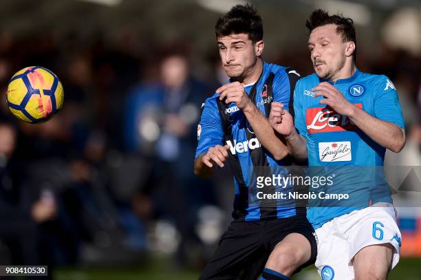 Riccardo Orsolini of Atalanta BC competes for the ball with Mario Rui of SSC Napoli during the Serie A football match between Atalanta BC and SSC...