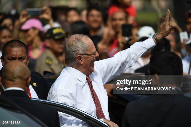 Peruvian President Pedro Pablo Kuczynski gets out of his car to greet people waiting to see Pope Francis pass by on his way to the Las Palmas air...