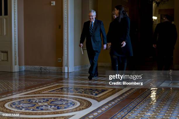 Senate Majority Leader Mitch McConnell, a Republican from Kentucky, left, walks toward the Senate Chamber at the U.S. Capitol in Washington, D.C.,...