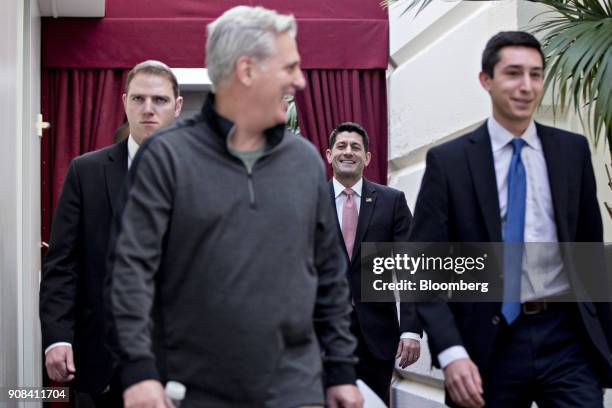 House Speaker Paul Ryan, a Republican from Wisconsin, center, smiles while walking to a GOP meeting with House Majority Leader Kevin McCarthy, a...