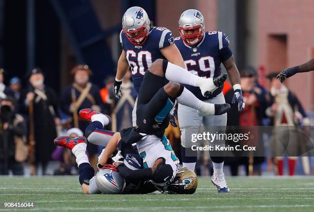 Tom Brady of the New England Patriots is tackled by Dante Fowler of the Jacksonville Jaguars in the second quarter during the AFC Championship Game...