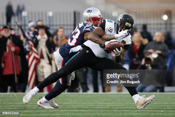 Marcedes Lewis of the Jacksonville Jaguars catches a pass as he is defended by Patrick Chung of the New England Patriots in the second quarter during...