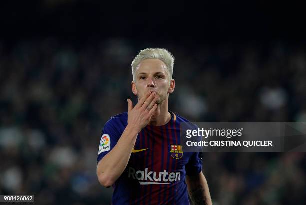 Barcelona's Croatian midfielder Ivan Rakitic celebrates after scoring a goal during the Spanish league football match between Real Betis and FC...