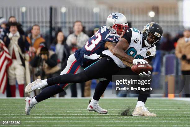 Marcedes Lewis of the Jacksonville Jaguars catches a pass as he is defended by Patrick Chung of the New England Patriots in the second quarter during...