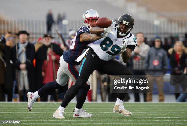 Marcedes Lewis of the Jacksonville Jaguars catches a pass as he is defended by Patrick Chung of the New England Patriots in the second quarter during...