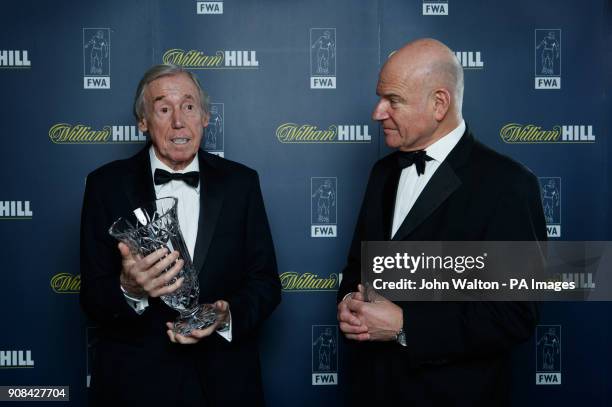 Gordon Banks receives the trophy on behalf of Pele from FWA Chairman Patrick Barclay during the Football Writers Association Tribute Night at The...