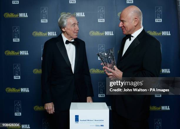 Chairman of the FWA Patrick Barclay prepares to hand the trophy to Gordon Banks who will receive it on behalf of Pele during the Football Writers...
