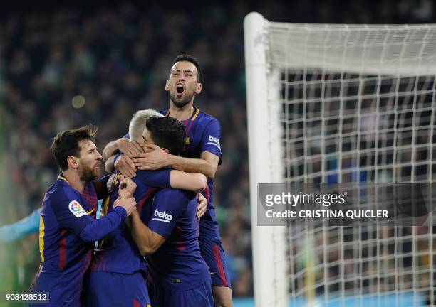 Barcelona's Uruguayan forward Luis Suarez celebrates with teammates after scoring a goal during the Spanish league football match between Real Betis...