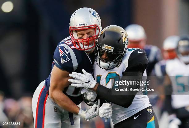 Rob Gronkowski of the New England Patriots is hit by Barry Church of the Jacksonville Jaguars in the second quarter during the AFC Championship Game...