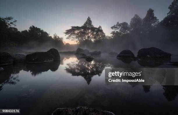 reflection of trees and rock on the pool with the misty atmosphere in the morning - impossiable fotografías e imágenes de stock