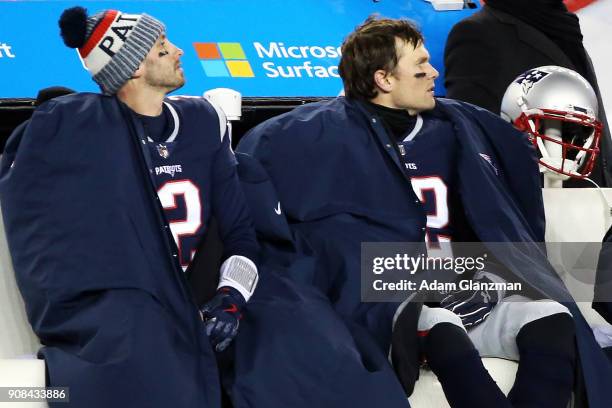 Tom Brady sits on the bench with Brian Hoyer of the New England Patriots during the fourth quarter in the AFC Divisional Playoff game against the...