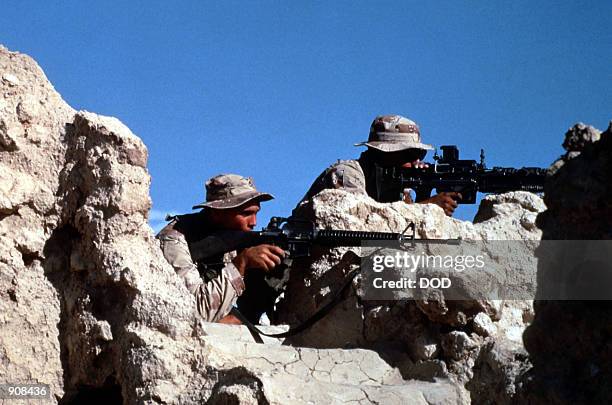 Soldiers take part in an urban warfare training exercise in an abandoned town during Operation Desert Shield. The soldier in the foreground is armed...