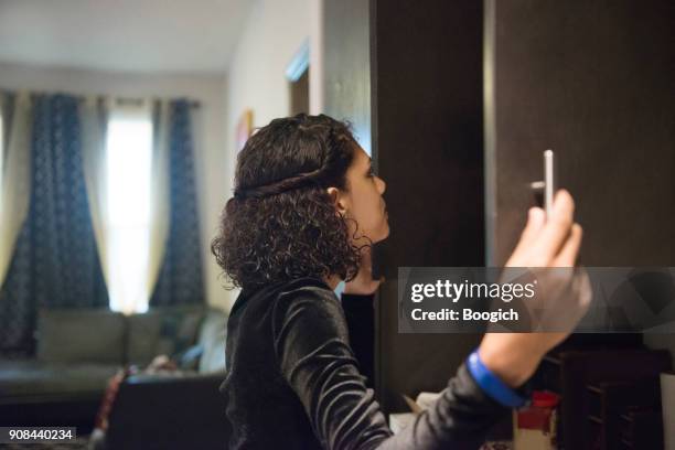 young millennial hispanic woman looking in kitchen cabinets orlando usa - beauty cabinet stock pictures, royalty-free photos & images