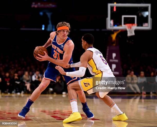 Ron Baker of the New York Knicks looks to pass as he is guarded by Jordan Clarkson of the Los Angeles Lakers during the first half at Staples Center...
