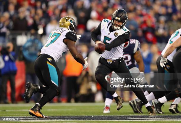 Blake Bortles of the Jacksonville Jaguars hands the ball off to Leonard Fournette in the second half during the AFC Championship Game against the New...