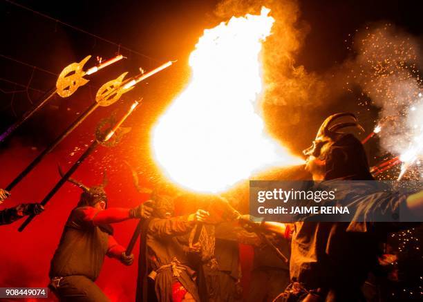 Revellers in costumes take part in the traditional "Correfoc" festival in Palma de Mallorca on January 21, 2018. - The Correfoc is a night of revelry...