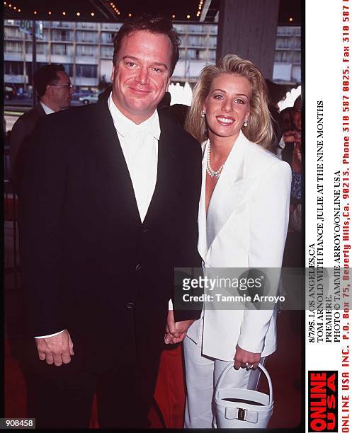 8/8/-95- LOS ANGELES,CA TOM ARNOLD WITH HID FIANCE JULIE AT THE PREMIERE FOR NINE MONTHS