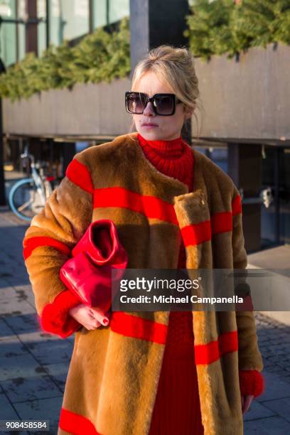 Lina Magassa seen wearing a coat from Stand with a bag from Dagmar during the first day of Stockholm Fashion Week outside of the Grand Hotel on...