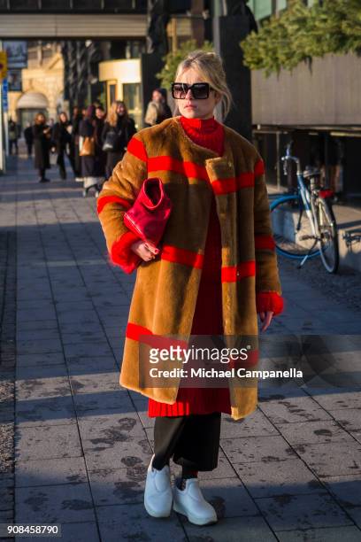 Lina Magassa seen wearing a coat from Stand with a bag from Dagmar during the first day of Stockholm Fashion Week outside of the Grand Hotel on...