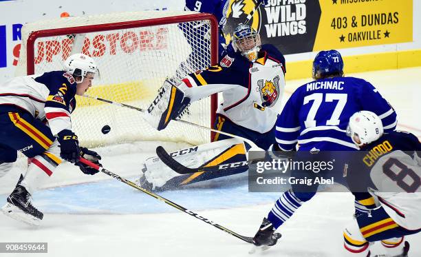 Albert Michnac of the Mississauga Steelheads fires the puck in the net past goalie Kai Edmonds and Tyler Tucker of the Barrie Colts during OHL game...
