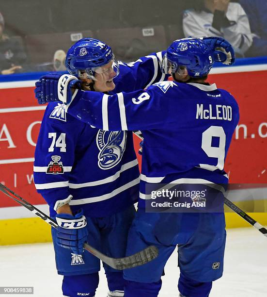 Michael McLeod celebrates his goal with teammate Owen Tippett of the Mississauga Steelheads against the Barrie Colts during OHL game action on...