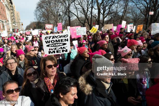 Demonstrator holds up a banner saying "Strong Women Scare Weak Men" among the crowd during the second annual Women's March in the borough of...