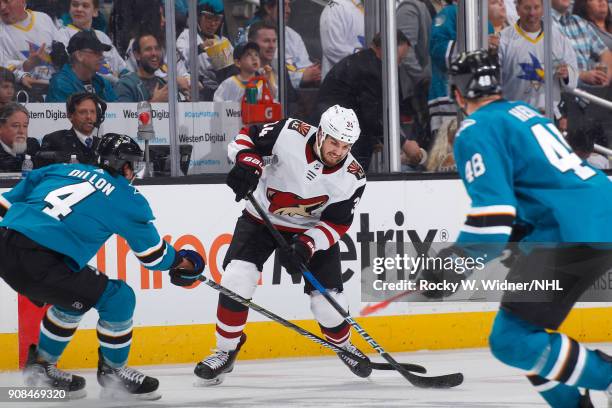 Zac Rinaldo of the Arizona Coyotes skates with the puck against Brenden Dillon of the San Jose Sharks at SAP Center on January 13, 2018 in San Jose,...