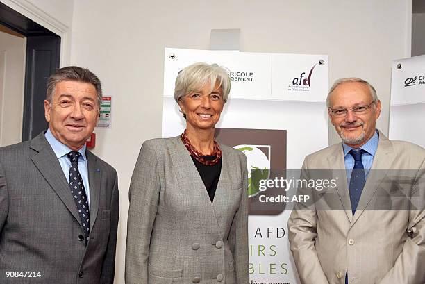 French Economy Minister Christine Lagarde poses with Chairman of Credit Agricole S.A, Rene Caron and Managing Director of France's international...