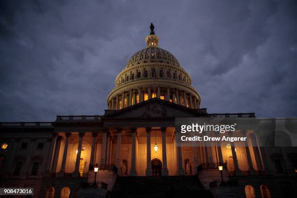 The U.S. Capitol is seen at dusk, January 21, 2018 in Washington, DC. Lawmakers are convening for a Sunday session to try to resolve the government...