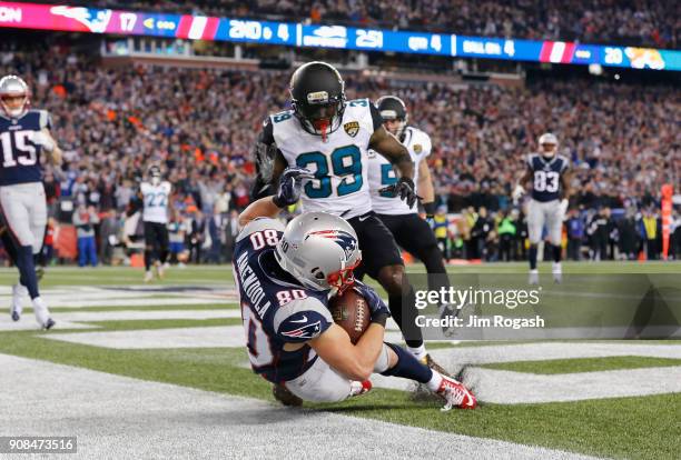 Danny Amendola of the New England Patriots catches a touchdown pass as he is defended by Tashaun Gipson of the Jacksonville Jaguars in the fourth...