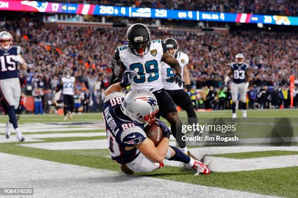 Danny Amendola of the New England Patriots catches a touchdown pass as he is defended by Tashaun Gipson of the Jacksonville Jaguars in the fourth...