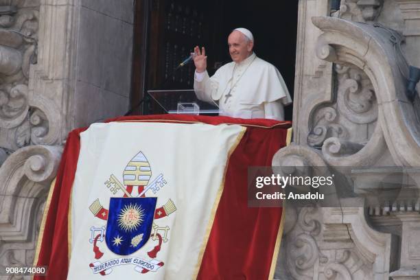 Pope Francis greets the crowd ahead of making a speech on the balcony of the Cathedral, during the last day of his visit in the Plaza de Armas in...