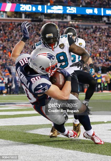 Danny Amendola of the New England Patriots catches a touchdown pass as he is defended by Tashaun Gipson of the Jacksonville Jaguars in the fourth...