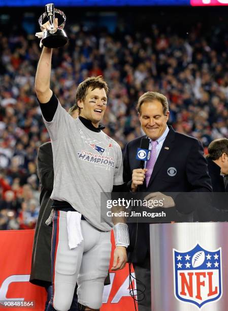 Tom Brady of the New England Patriots holds the Lamar Hunt trophy as he is interviewed by Jim Nantz after the AFC Championship Game against the...