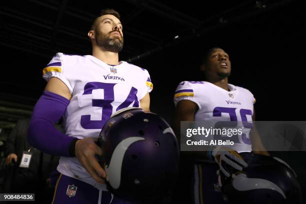 Andrew Sendejo and Xavier Rhodes of the Minnesota Vikings walk out on the field for warm ups prior to the NFC Championship game against the...