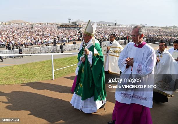 Pope Francis walks to the altar to celebrate mass at the Las Palmas air base in Lima on January 21, 2018. Pope Francis was preparing to wrap up his...